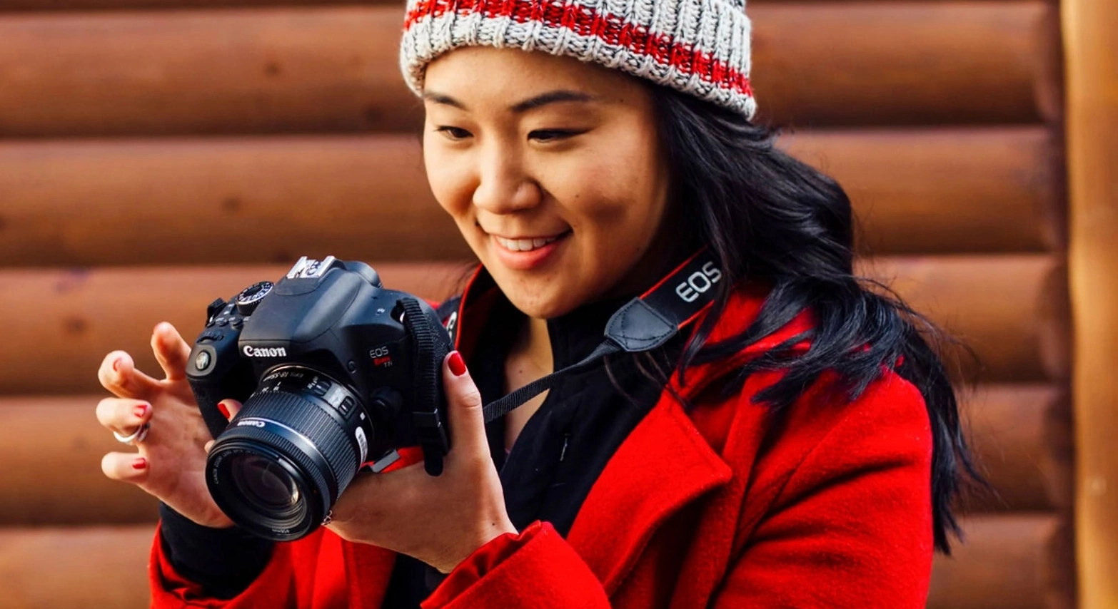 people on beach photographing the water
